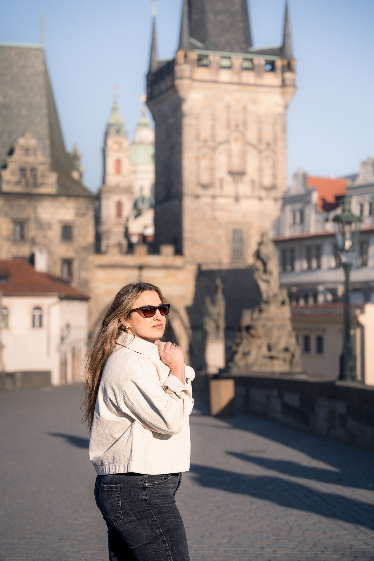 Woman by Charles Bridge in morning light