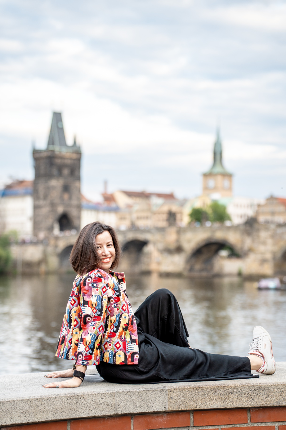 Woman by the Vltava with Charles Bridge behind